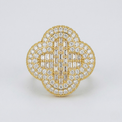 Gold and diamond brooch on a light gray background