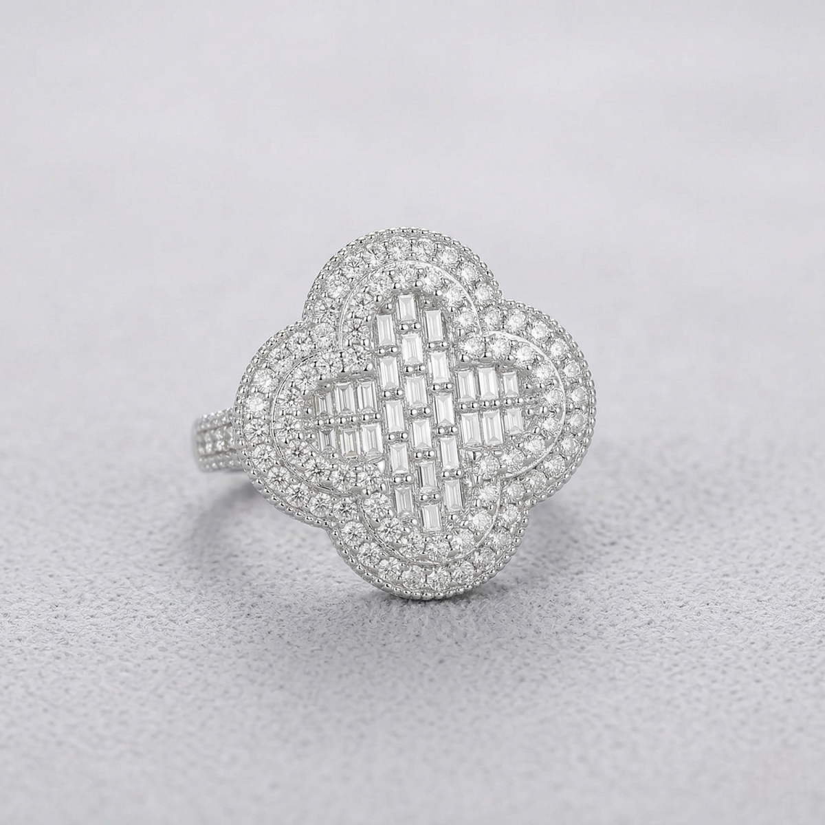 Silver ring with diamond accents on a light gray background