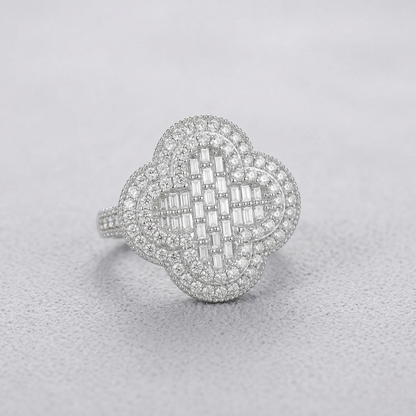 Silver ring with diamond accents on a light gray background