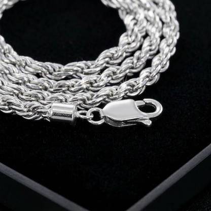 Silver rope chain necklace with clasp on a black background