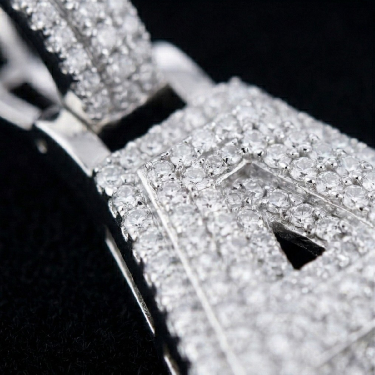 Close-up of a diamond-encrusted ring with a black background