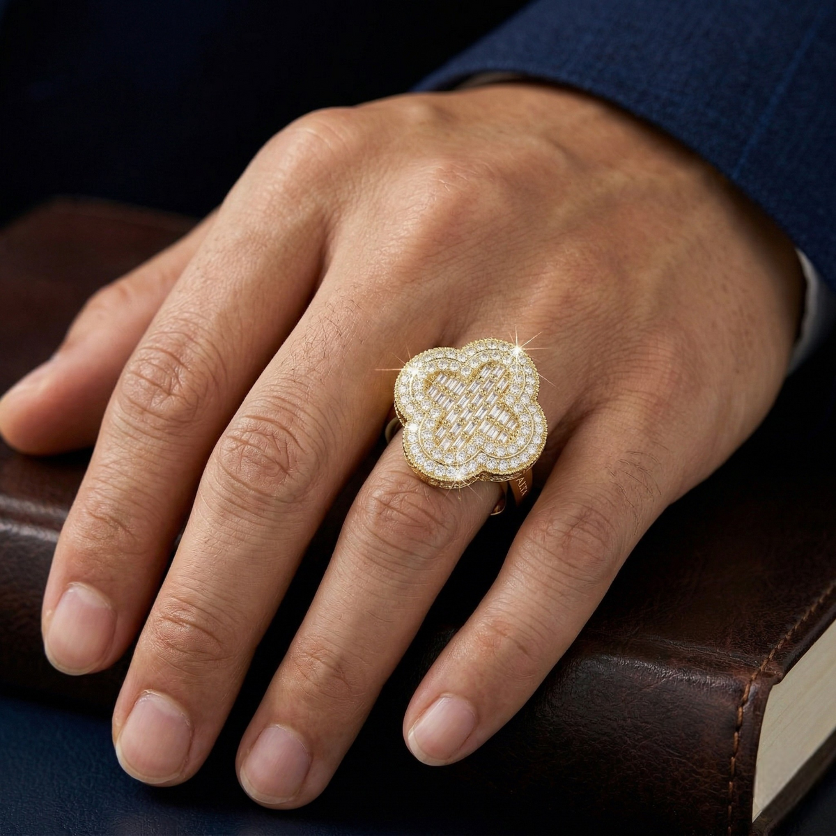 Hand wearing a gold and diamond ring on a dark surface