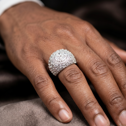 Close-up of a hand wearing a sparkling diamond ring on a dark background
