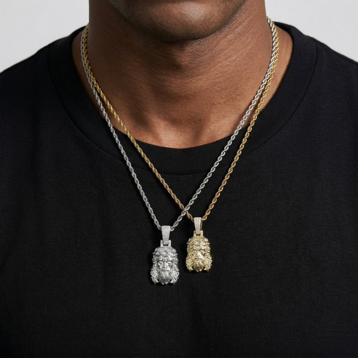 Two necklaces with pendants on a black shirt