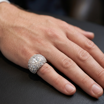 Hand wearing a large diamond ring on a dark surface