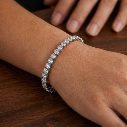 Silver bracelet on a wrist with a wooden surface in the background