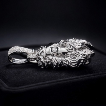 Silver lion head pendant with gemstones on a black background