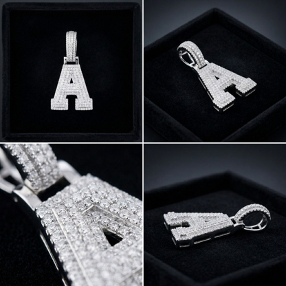 Silver 'A' pendant with diamond accents on a black background