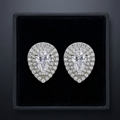 Pair of diamond earrings in a black box on a dark background