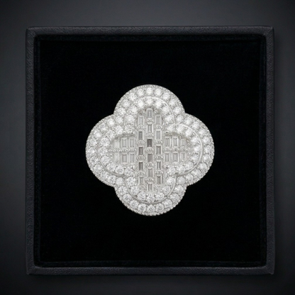 Diamond brooch in a black display box on a dark background