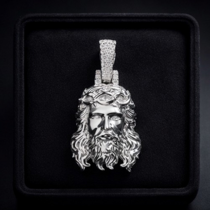 Silver pendant of a bearded figure with a crown of thorns on a black background