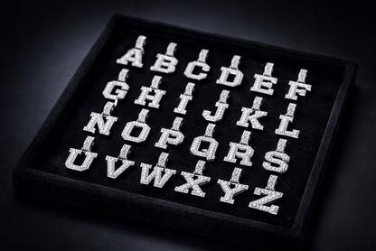 Alphabet letters displayed on a black tray against a dark background